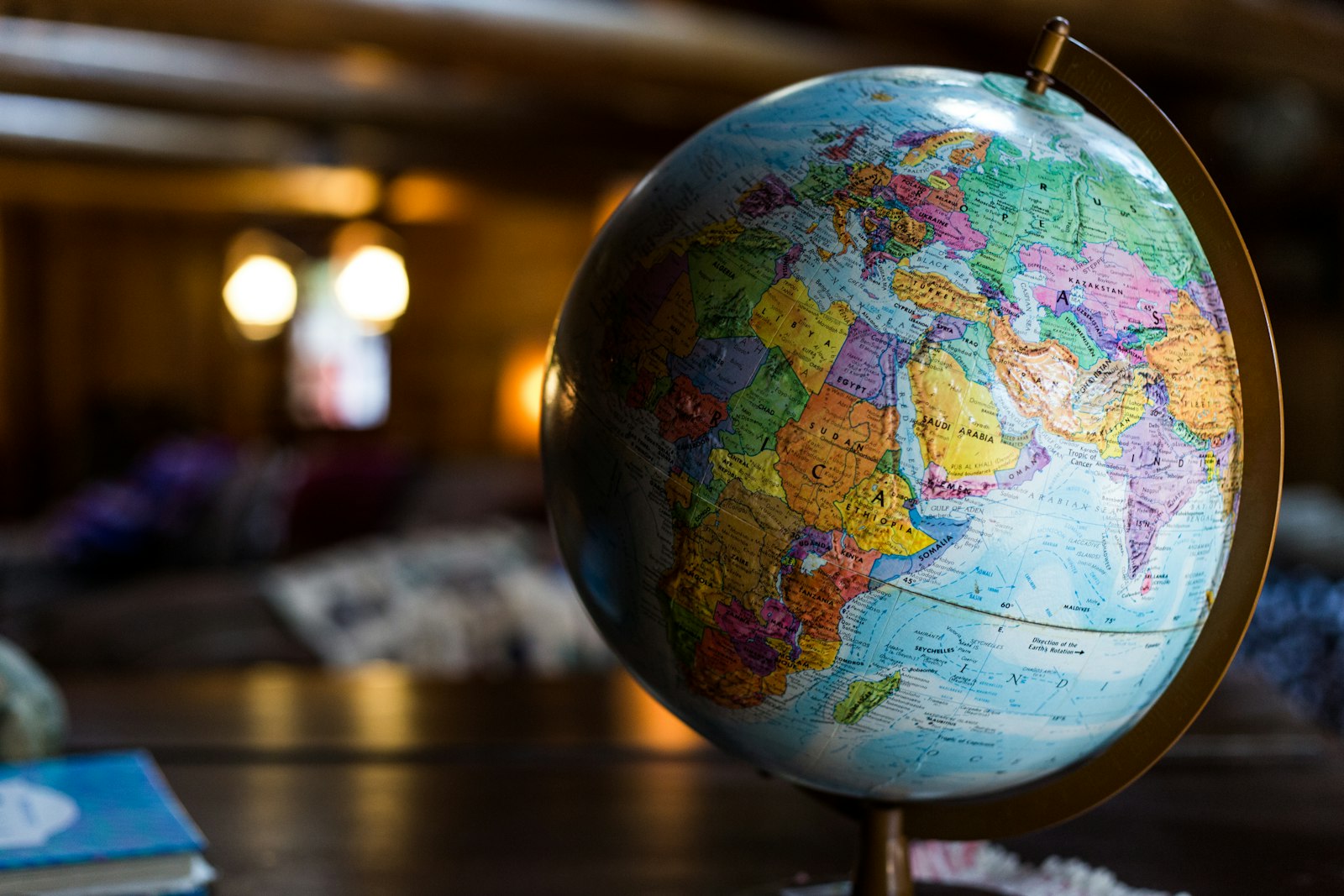 A globe on a desk beside travel documents